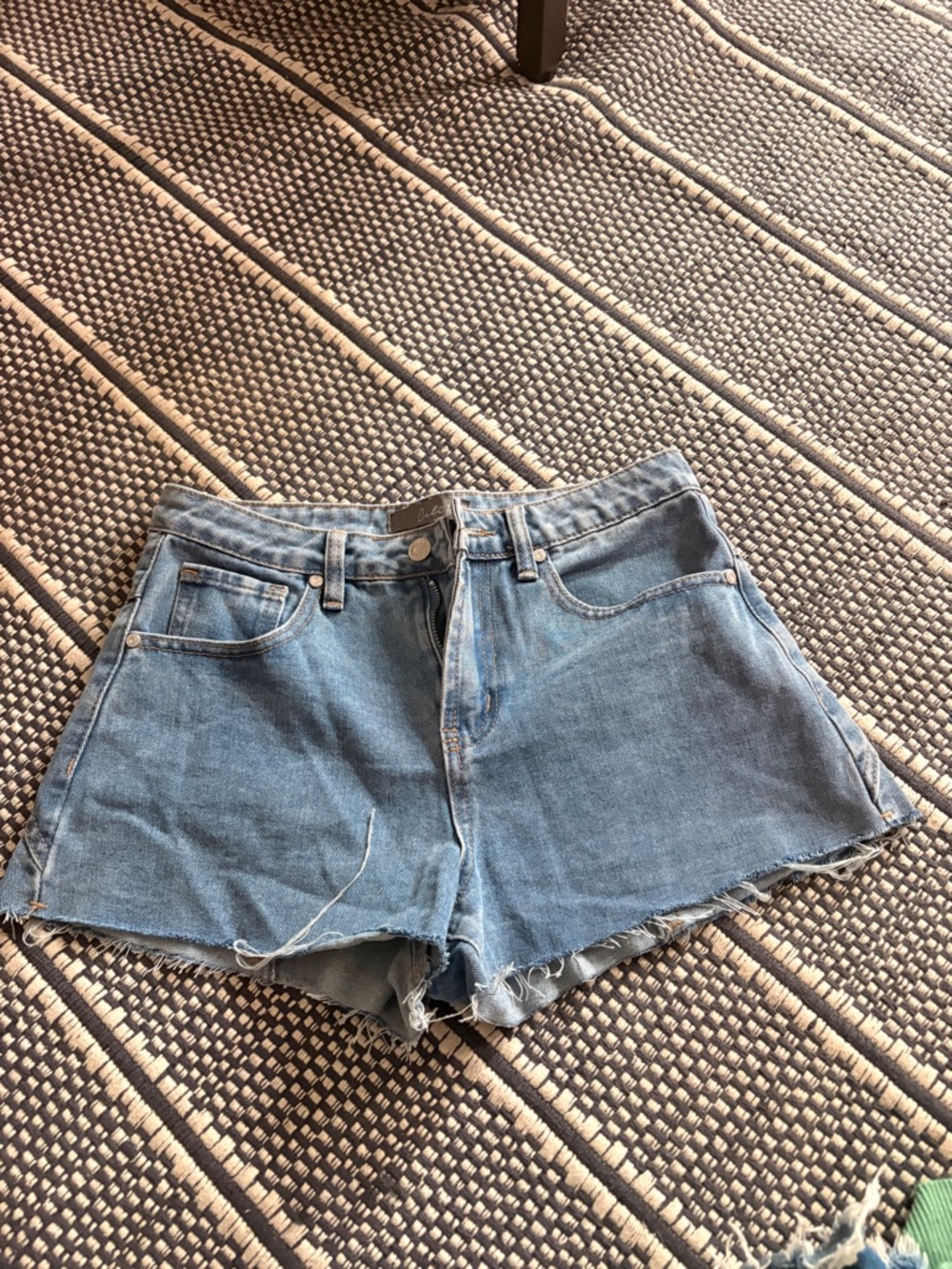 High-Rise Light Blue Denim Cutoff Shorts with Frayed Hem